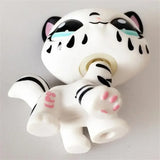 Mini pet shop kitty figure – white with black stripes and pink paw pads, lying on its back