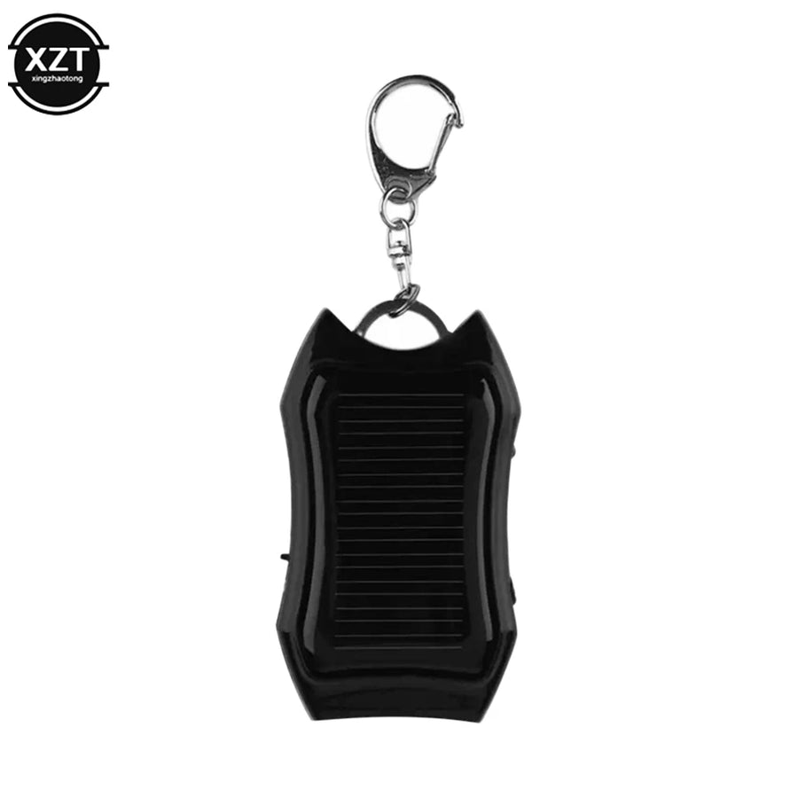 Black solar-powered keychain device with a keyring on a white background, featuring the brand 'XZT'.