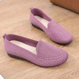 Pair of purple loafers on a wooden floor