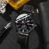 Black wristwatch with detailed face on a dark textured surface