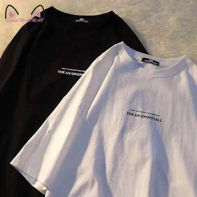 Man's T-shirt Fashion Letter Print T Shirt Man in black and white colors displayed on a soft surface.