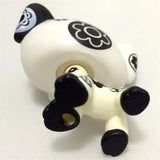 Mini pet shop puppy figure – white with black floral patterns, lying on its back showing paws