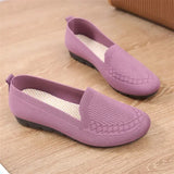 Pair of purple loafers on a wooden floor