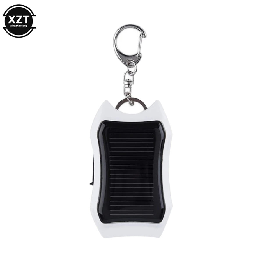 White keychain device with solar panel on a white background, featuring the brand 'XZT'.