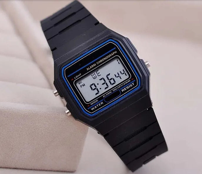 Men's black LED digital military watch with blue accents showing time on display, vintage digital wristwatch on beige stand.