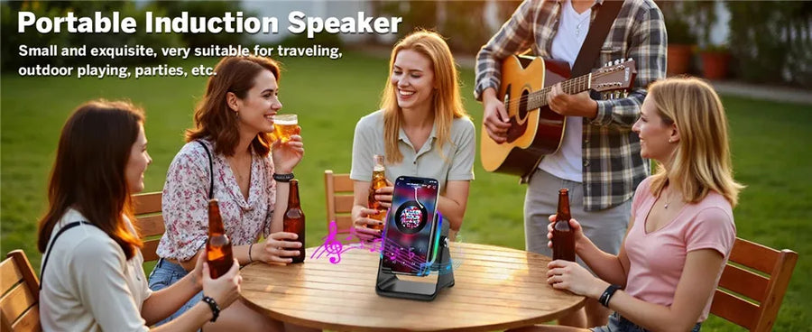 Portable induction speaker on a table with people around, one playing guitar.