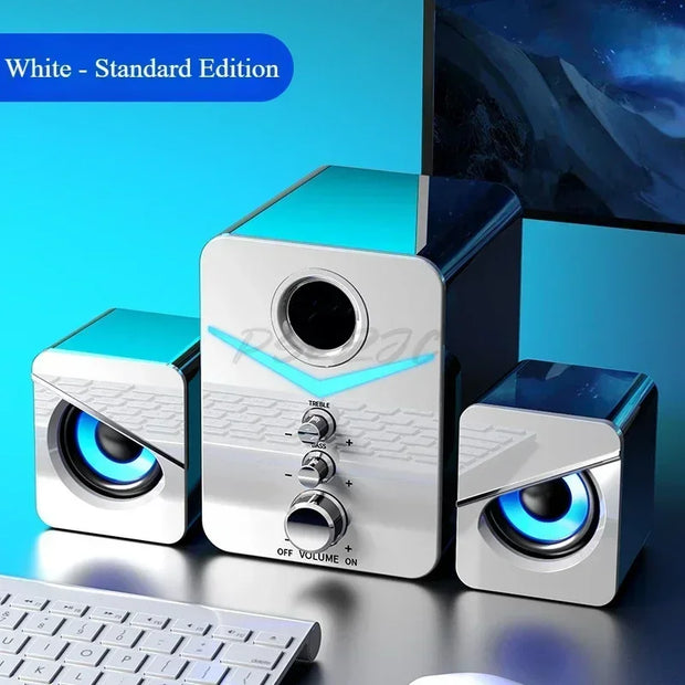 Wired desktop speakers featuring a sleek silver design with illuminated accents and volume control.