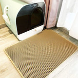 Covered cat litter box with perforated honeycomb double-layer cat litter trapping mat placed in front on a wooden floor
