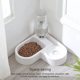 White pet feeder with a bowl of food and a water bottle on a wooden floor.