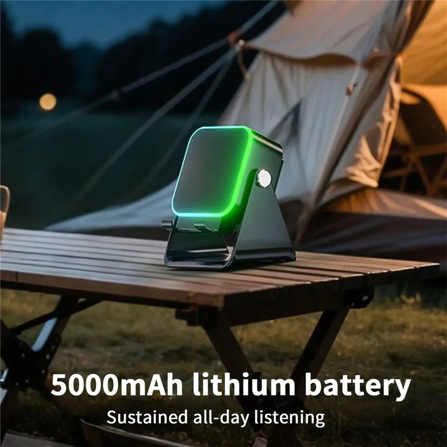 Portable device with green light on a camping table in front of a tent