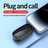 Small black device with solar panel on a blue background, next to a smartphone. Text 'Plug and call' and 'New upgrade comes with lanyard' is displayed.