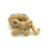 Mini pet shop kitty figure – beige, lying on its back showing molded markings