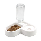 Pet feeder with a clear water bottle attachment on a white background