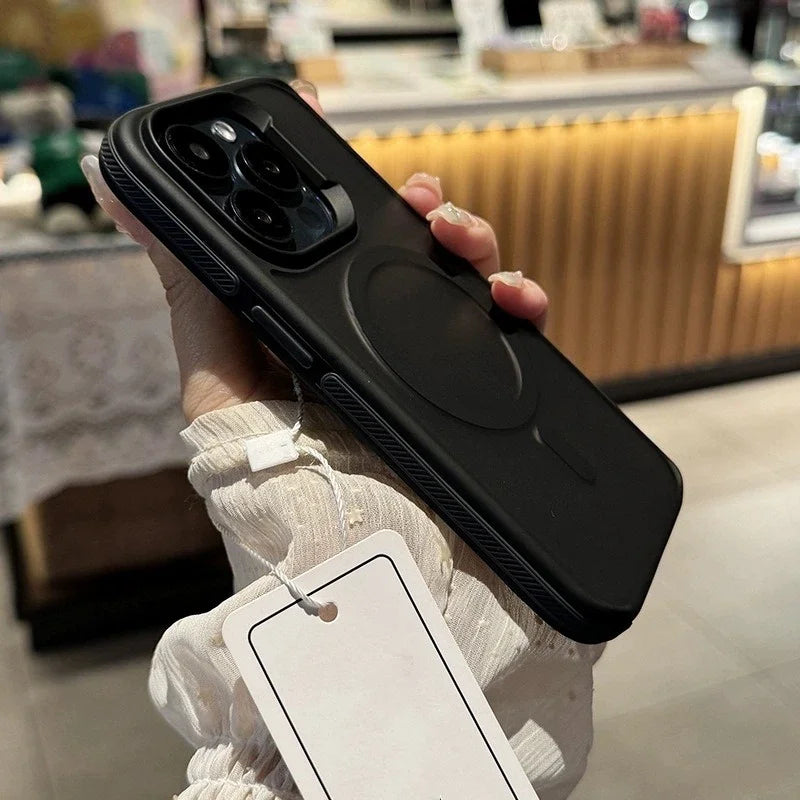 Person holding a black phone case with a tag in a store setting