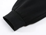Mens fleece lined jogger sweatpants – close-up of black sweatshirt sleeve on white background