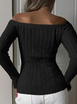 Back view of model wearing black off-shoulder cable-knit sweater, showing the knit texture