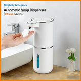 Automatic soap dispenser being used with a hand, placed on a bathroom counter.