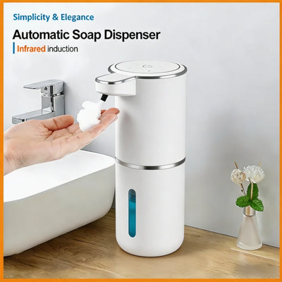 Automatic soap dispenser being used with a hand, placed on a bathroom counter.