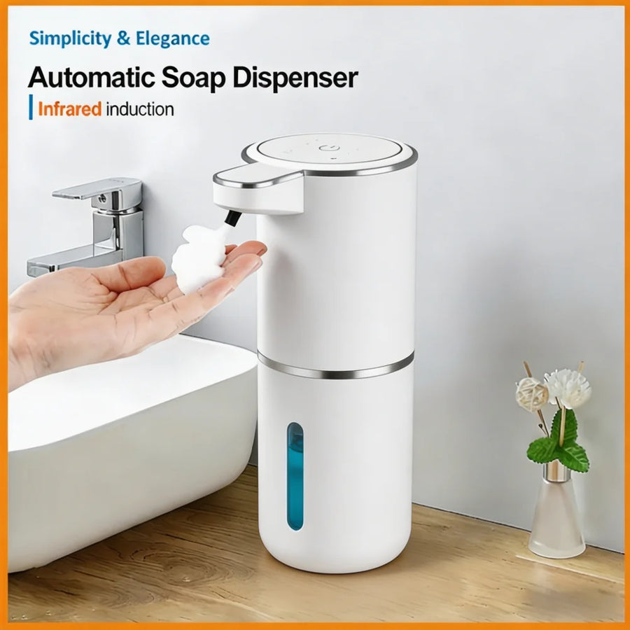 Automatic soap dispenser being used with a hand, placed on a bathroom counter.