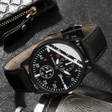 Black wristwatch with detailed face on a textured surface