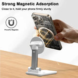 Black foldable MagSafe phone holder on a wooden surface.