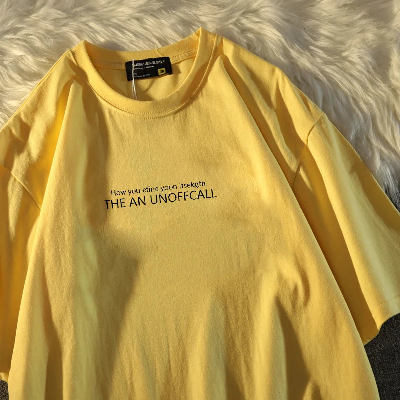 Man's T-shirt Fashion Letter Print T Shirt Man in yellow color with graphic text design on a fluffy background.