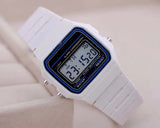 Men's white LED digital military watch with blue accents showing time on display, vintage digital wristwatch on beige background.