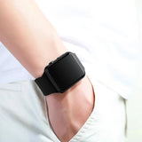 Person wearing a black LED digital sport watch with black screen on wrist, casual unisex digital watch on light background.