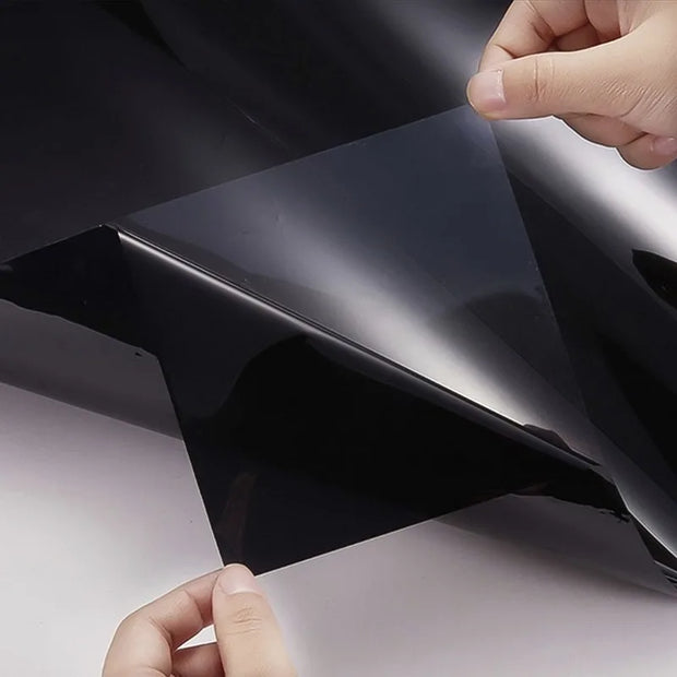 High heat resistant car window tint being handled, showcasing protective vinyl wrap for enhanced vehicle privacy and sun protection.