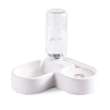 Clear glass bottle with white ceramic holder on a white background