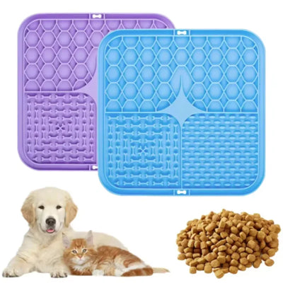 Two silicone mats, one purple and one blue, with a dog and cat and a pile of kibble on a white background.