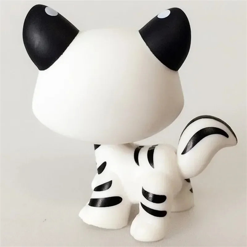 Mini pet shop kitty figure – white with black ears and striped body and tail, rear view