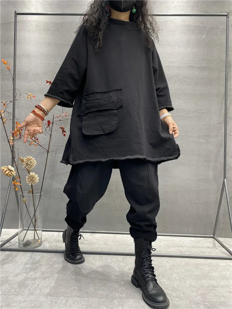 Womens plus size long sleeve top in black, baggy loose fit t-shirt with pants, standing pose