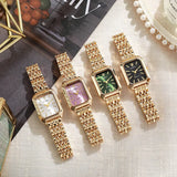 Four women's gold quartz watches with different dial colors on textured surface