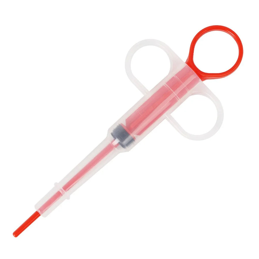 Red pet pill feeder syringe with soft tip and clear barrel on white background – pill dispenser for dogs and cats