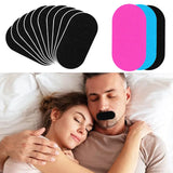 Black anti-snoring mouth tape strips fanned out and stacked, with pink and blue color options