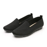 Pair of black loafers on a white background