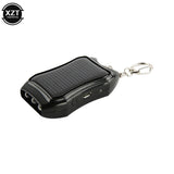 Black portable device with solar panel and keychain clip on a white background, featuring the brand 'XZT'.