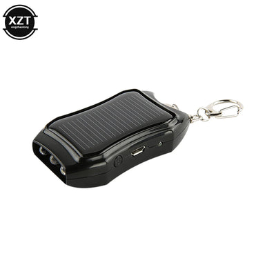 Black portable device with solar panel and keychain clip on a white background, featuring the brand 'XZT'.