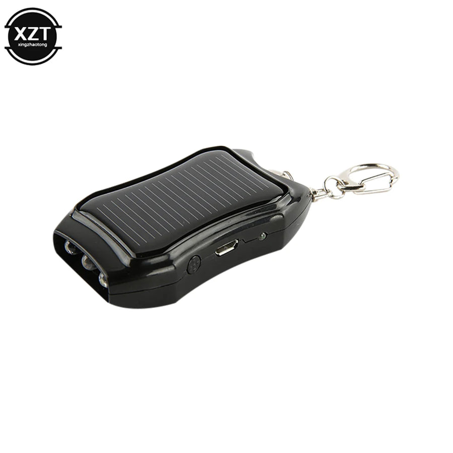 Black portable device with solar panel and keychain clip on a white background, featuring the brand 'XZT'.
