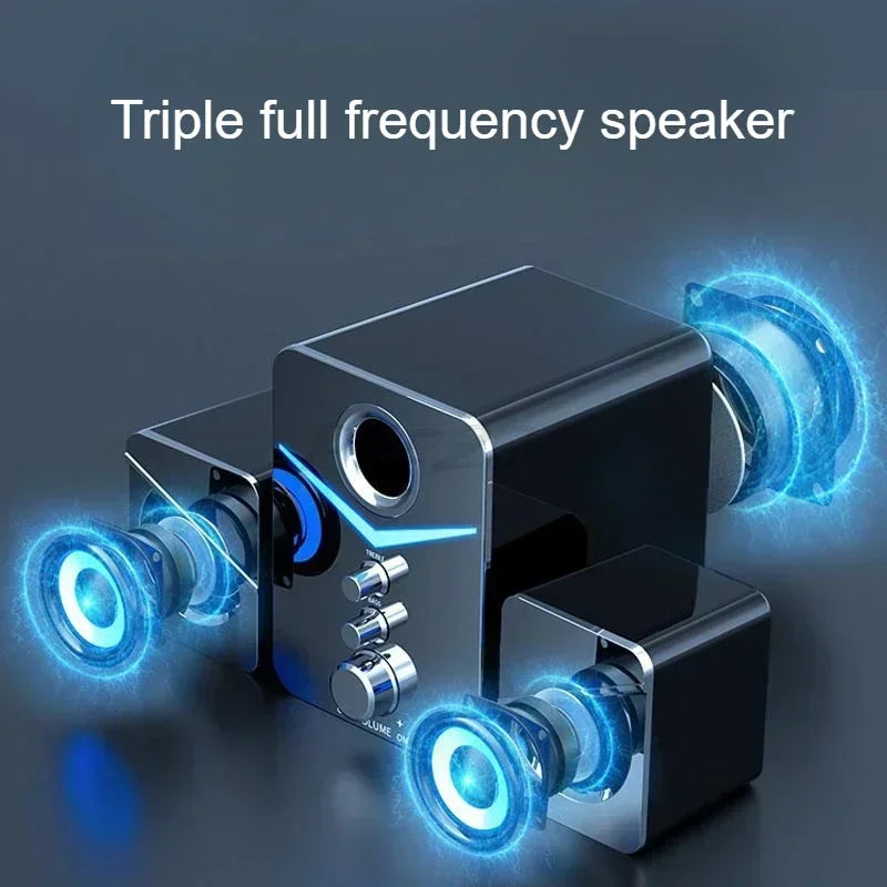 Wired desktop speakers with glowing blue accent lighting and an illuminated control dial.