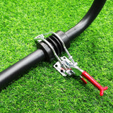 A close-up of a black hose secured with a silver metal clamp and red handle tool, placed on bright green artificial grass.